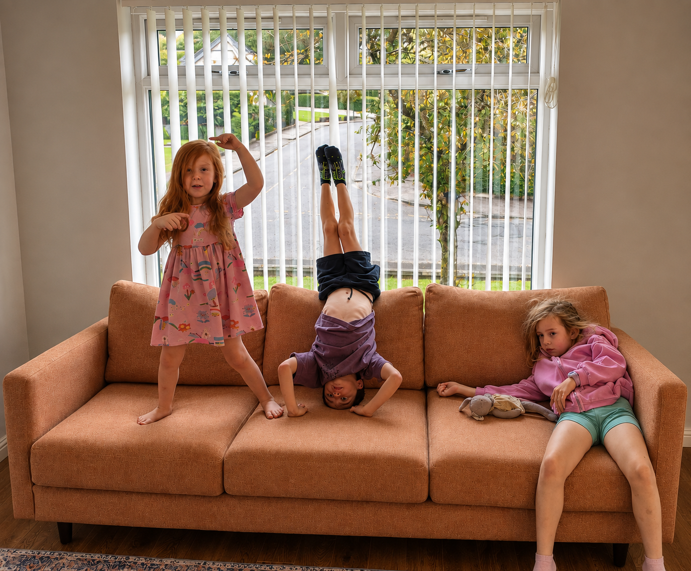 Four-year-old Craft sofa with three children sitting, lying and doing a handstand on it