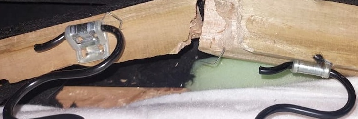 Broken internal hardwood sofa frame exposed during a repair