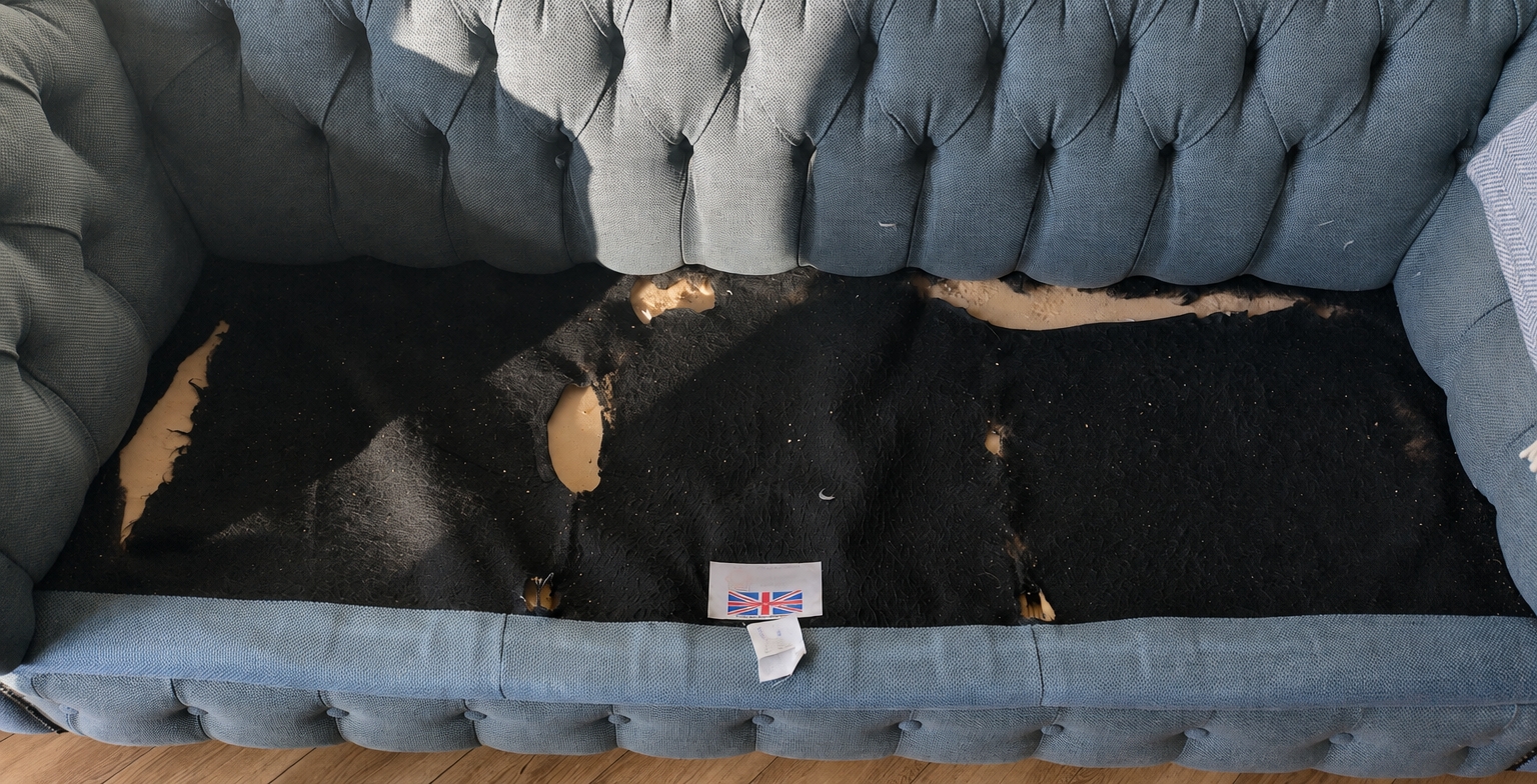 Chesterfield sofa interior showing worn seating area and construction quality